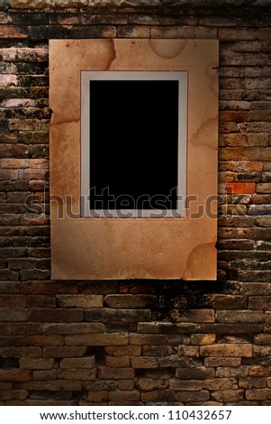 old paper photo frame on old brick wall texture, grunge industrial interior Uneven diffuse lighting version (Save Paths For design work)