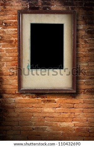 Photo frame on old brick wall texture, grunge industrial interior Uneven diffuse lighting version (Save Paths For design work)