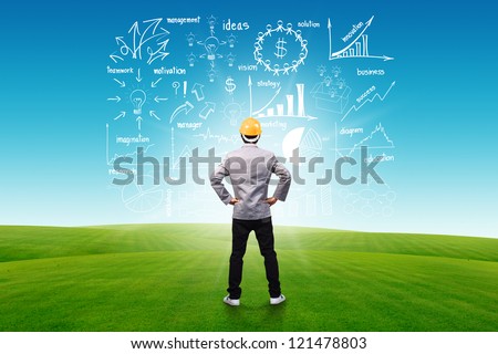 Engineer person standing near a business plan concept idea, on blue sky and green grass background