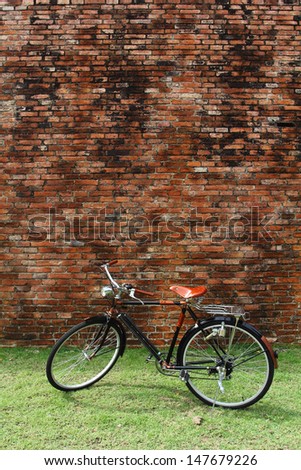 Vintage bicycle and red brick wall, vintage bike. Retro stylish cycling in town