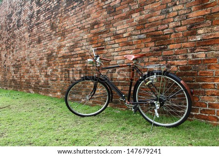 Vintage bicycle and red brick wall, vintage bike. Retro stylish cycling in town