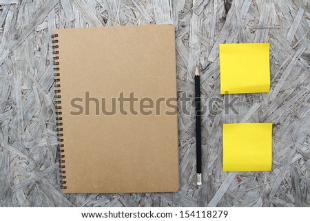 Recycled paper notebook front cover on wood background