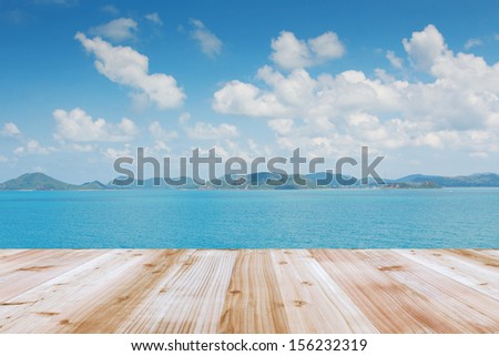 Wood terrace on the beach and sun light