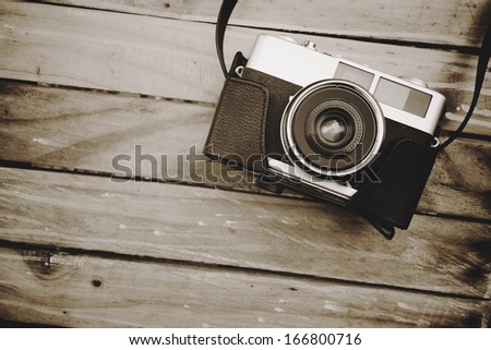 Old Camera And On Wooden Table, Sepia Vintage Photo With Space For Text Or Image For Design Work