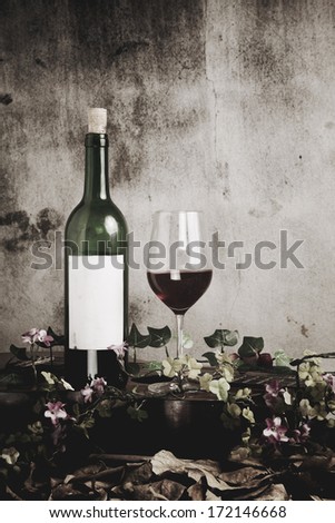 Still life of red wine bottle and wine glass