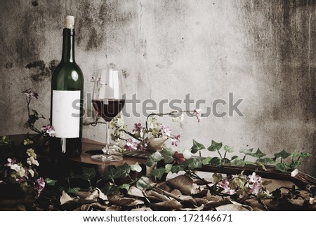 Red wine bottle and wine glass on acoustic guitar, Still life photography