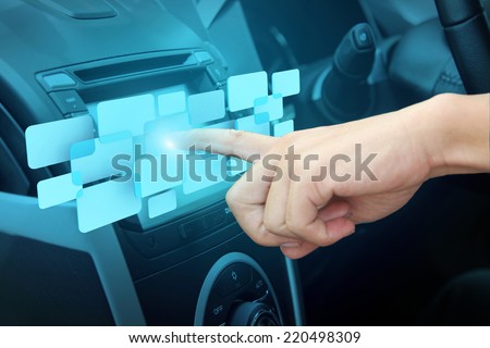 Transportation, future technology and vehicle concept - man using car system control pushing panel button screen interface modern design idea concept