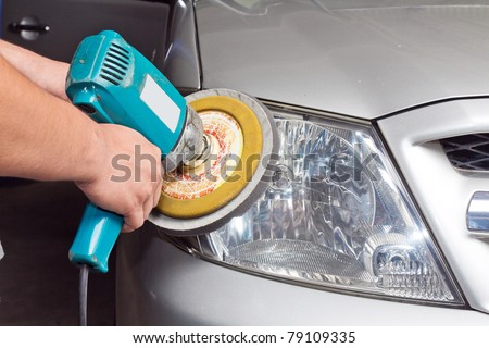 Car headlights with power buffer machine at service station - a series of CAR CARE images. closeup Useful as background for design-works.