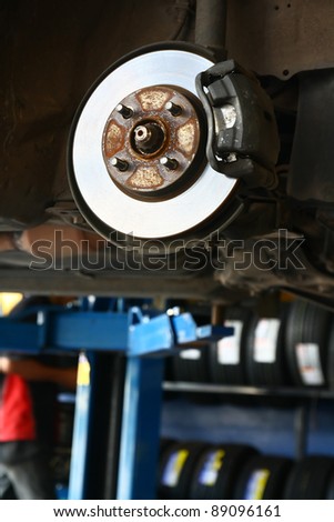 changing a wheel of a car in the garage. Closeup Useful as background for design-works.