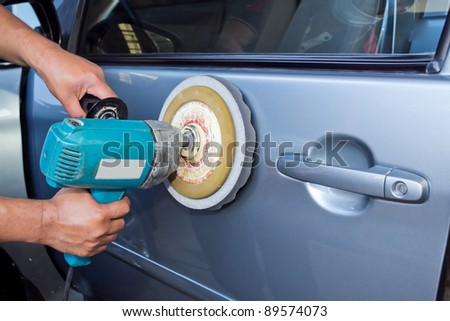 Polishing the car. with power buffer machine . CAR CARE images closeup Useful as background for design-works.