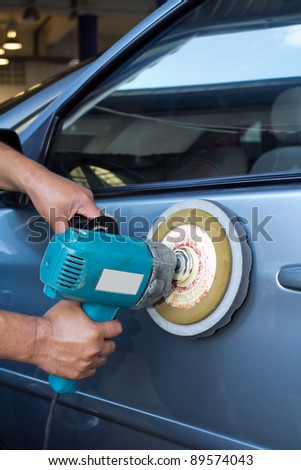 Polishing the car. with power buffer machine . CAR CARE images closeup Useful as background for design-works.