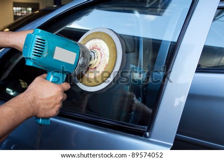 Car Glass polishing with power buffer machine. CAR CARE images. closeup Useful as background for design-works.