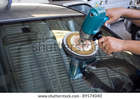 Car Glass polishing with power buffer machine. CAR CARE images. closeup Useful as background for design-works.