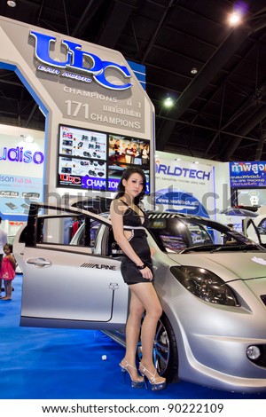 BANGKOK - DECEMBER 4: Female presenters model at the Toyota yaris car audio UDC Booth on display at the 28th Thailand International Motor Expo on December 4, 2011 in Bangkok, Thailand.