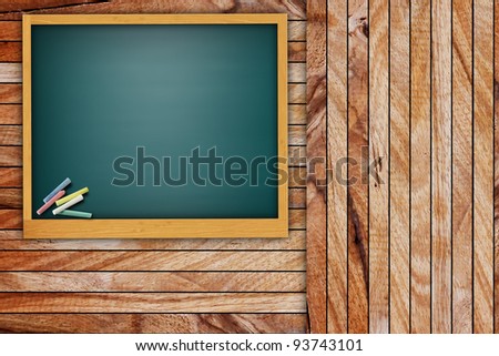 Blank chalkboard on wooden wall