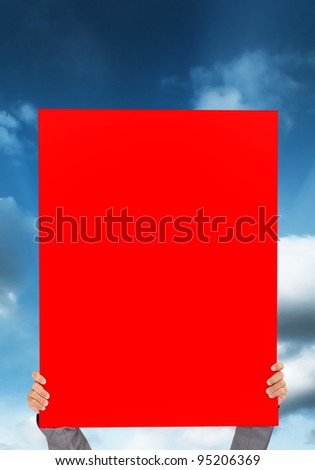 hand holding blank red Poster on blue sky background