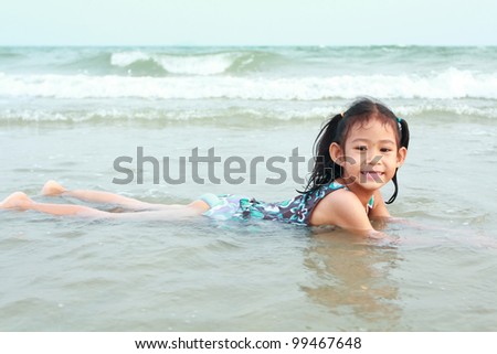 Happy asia little girl swimming at sea