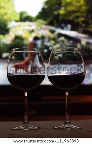 Romantic evening concept - wine and movie - lit by ambient light, and T.V. screen