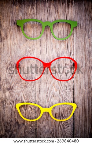Glasses frames on wooden wall - vignetting effect