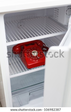 Hidden vintage British red phone in a fridge