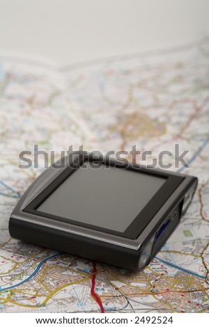 GPS unit seated on a road map