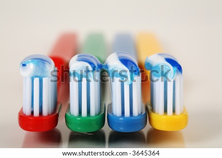 toothbrushes with toothpaste. coloured toothbrushes with