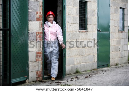 Young woman leaving a building wearing protected clothing