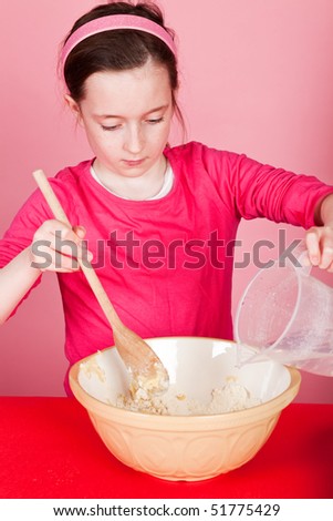 Young girl mixing a cake mixture