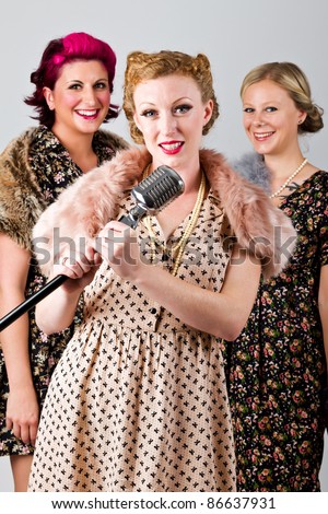 1940's 3 part harmony singing group on a grey background