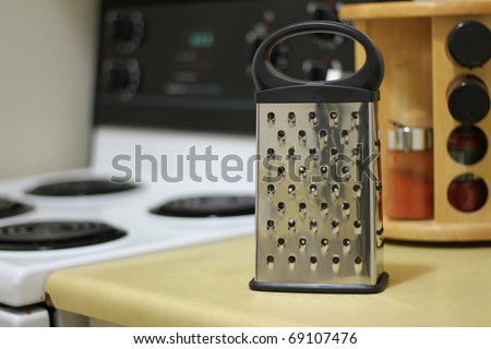 A cheese grater in a kitchen