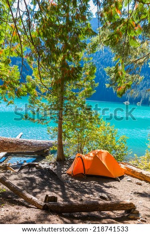 Majestic mountain Cheakamus turquoise water lake in Canada with campsite and orange tent