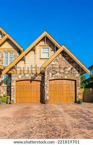 Double door garage of a custom built luxury house  in a residential neighbourhood in Canada.