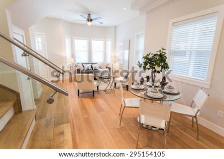 Spacious bright living room and dining room with leather chairs. Interior design.