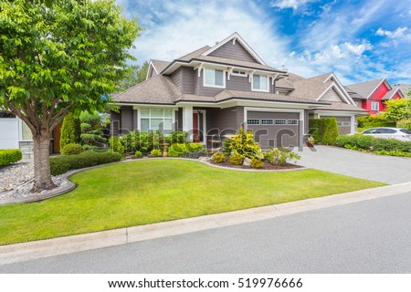 Nicely trimmed and manicured garden in front of a luxury house