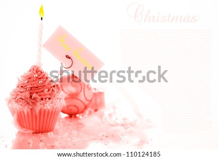 Christmas cupcake with decoration and merry christmas label on white background.