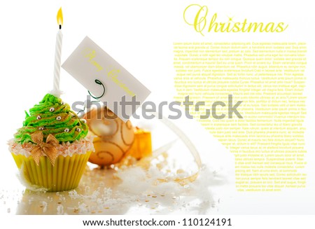 Christmas cupcake with decoration and merry christmas label on white background.