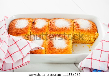 Butter cake in a white pan with sugar on the top