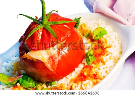 One stuffed tomato on a white plate