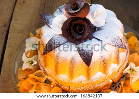 bundt cake on plate decorated with chocolate flowers