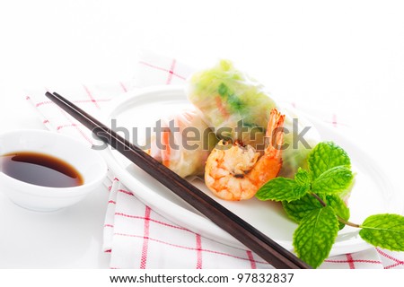 Vegetarian spring roll with carrot, soy sprouts and shrimp on white background as a studio shot