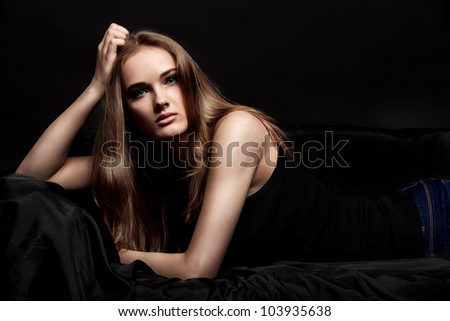 Fashion shot of an attractive young woman posing at studio.