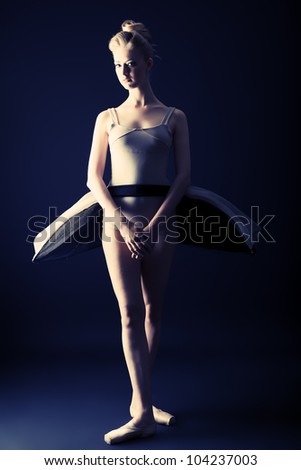 Beautiful ballet dancer posing at studio.