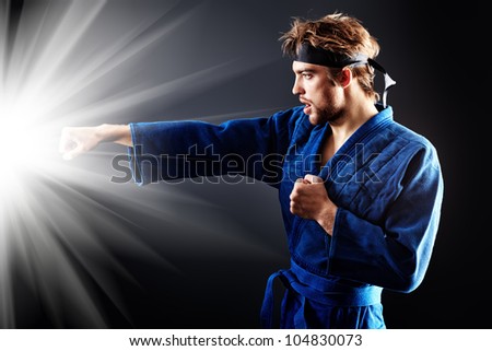Martial arts fighter posing at studio.