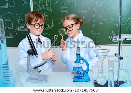 Two children scientists making experiments in the laboratory. Educational concept. Early development of children.