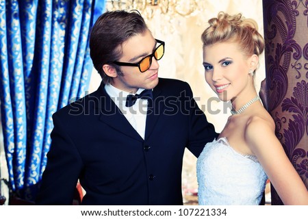 Charming bride and groom on their wedding celebration in a luxurious restaurant.