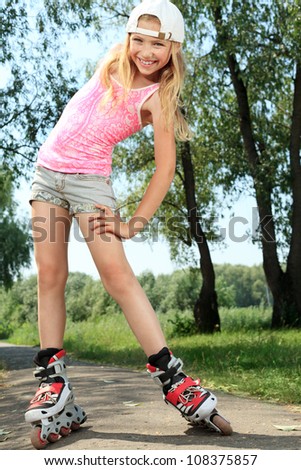 Cute girl in roller skates at a park.