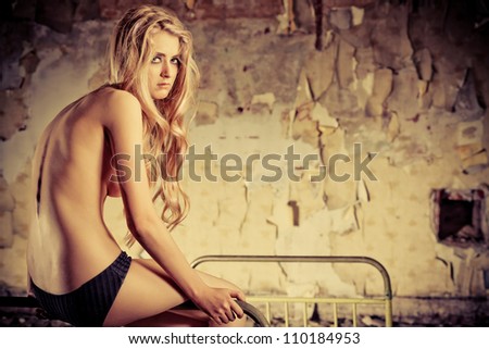 Beautiful lonely woman in the old house.
