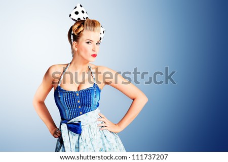 Beautiful young woman with pin-up make-up and hairstyle posing in studio.