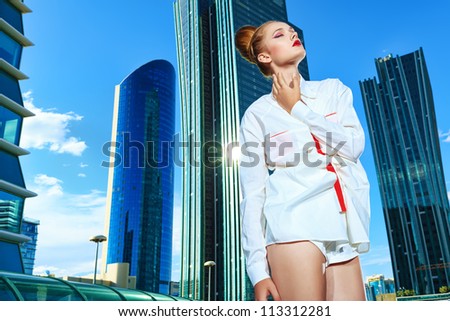 Fashion model posing over big city background.