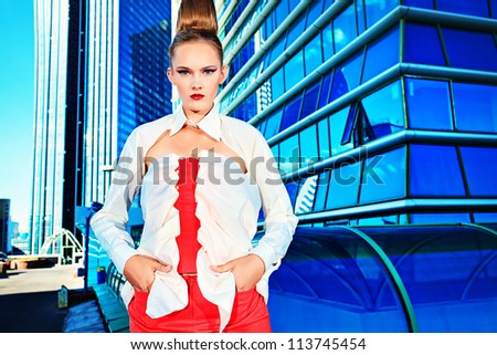 Fashion model posing over big city background.
